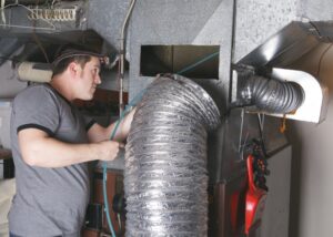 technician-inspecting-ductwork
