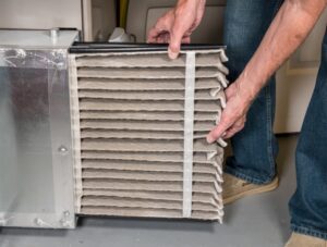 a-person-changing-a-furnace-air-filter