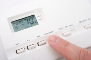 close-up-of-person-setting-a-thermostat